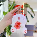 Close-up of white plush fortune cat keychain holding a red sign with peace characters - White Chain