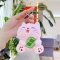 Close-up of pink plush cat keychain with green health charm and silver metal clasp - Pink With Chain