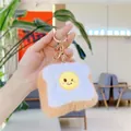 Close-up of plush toast keychain featuring a winking fried egg and gold metal ring - Toast (Gold Clasp)