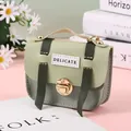 Detail of mini green two-tone purse with gold clasp and delicate embroidery - Green