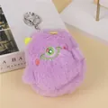 Detail of a purple plush monster coin purse with a green eye and yellow horns - Purple (Green Eye)