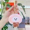 Close-up of pink plush strawberry cake pendant with embroidery smile and gold keychain - Gold Clasp / Pink