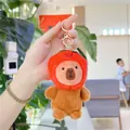 Close-up of plush capybara keychain with red strawberry hat and gold metal lobster clasp - Strawberry Style (Red with Golden Buckle)