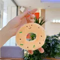 Macro detail of plush donut keychain with embroidery and silver metal ring - Smiling Expression / Plain Chain