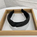 Cross-knot headband in black raffia woven fabric with minimalist aesthetic design - Black