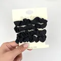 Set di quattro elastici in tessuto nero su cartoncino per code e capelli raccolti - Stile Design Pieghettato / Nero