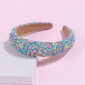 Detailed shot of padded candy color headband with colorful grain texture on a pink background - Blue