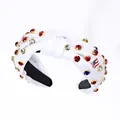 White knotted headband with colorful rhinestones and American flag decorative accents - White