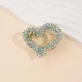 Detailed view of heart-shaped hair claw clip with blue and silver sparkling rhinestones - Green