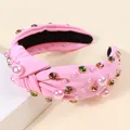 Cerchietto rosa con nodo decorato con perle e strass colorati su supporto bianco - Rosa Rosso