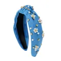 Close-up of light blue knotted headband with white pearls, rhinestones and floral details - Blue