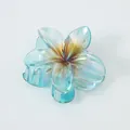 Detailed close-up of iridescent frangipani hair claw clip with strong non-slip teeth - Large (8cm) / Iridescent Blue