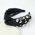 Detail of knotted black headband with sequins and large rhinestones in claw settings - Black