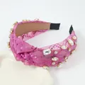 Detailed view of fuchsia knot headband with sparkling sequins and luxury crystals - Rose Red