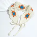 Close-up of handmade crochet floral headband with orange and blue knit patterns - Checkered Orange Blue