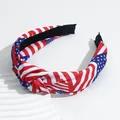 Detail of knot headband featuring American flag stars and stripes on a textured display - Stars Stripes Knotted Style / Red
