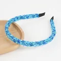 Detail of blue shimmering knit headband with soft texture and comfortable end tips - Sky Blue