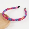 Detailed macro shot of shimmering knit headband featuring vibrant multicolored metallic yarn - Pale Blue