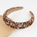 Macro detail of hand-beaded headband featuring colorful smiley faces and velvet lining - Black