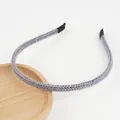 Close-up of grey knitted headband with shiny metallic thread on wooden tray - Light Gray