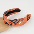Detail of orange Halloween knotted headband with pumpkin, spider web and bat patterns - Pumpkin Bat Style / Orange