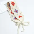 Detail of crochet floral headband featuring orange and purple geometric patterns - Diamond Purple Orange Red
