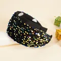 Macro shot of wide sequined headband showing colorful metallic reflections and velvet base - Colorful