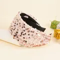 Detail showing the shiny pink sequins texture and black inner lining of the wide headband - Pink