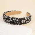 Detail of wide headband with shiny black rhinestones and white pearls on soft fabric - Black