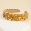 Detail shot of wide headband with glittering gold crystals and white faux pearls - Gold