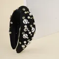 Black knotted sports headband with pearls, crystals and baseball charms on display - Black