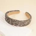 Detailed macro view of wide headband with shiny grey rhinestones and white pearls inlay - Gray
