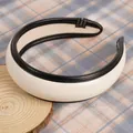 Detail of wide cream PU leather headband with black piping and Hand Made label - White