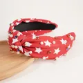 Close-up of red knotted headband with white stars, pearls and sparkling rhinestones - Red