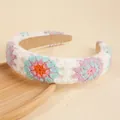 Bohemian white crochet headband with colorful floral embroidery on a wooden tray - Blue & Pink