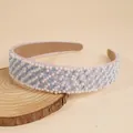 Detail of pink pearl headband with blue gems and non-slip velvet lining on wood - Blue
