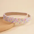 Fashionable padded headband featuring colorful pearls on a wooden display plate - Colorful