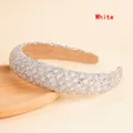 Detailed close-up of sparkling rhinestone padded headband with non-slip velvet inner lining - White