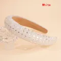Close-up of white sponge headband featuring dense sparkling crystal rhinestones and texture - White