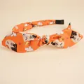 Detail of Halloween bow headband with orange pumpkin, ghost, and bat prints - Orange