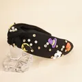 Halloween knot headband with ghost pumpkin motifs and pearls on a display stand - Black
