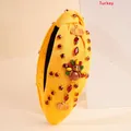 Yellow knotted headband with turkey and pumpkin charms featuring red rhinestones - Turkey