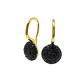 Close-up of gold hook earrings with round pendants featuring black pavé-set gemstones - Gold + Black