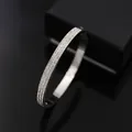 Moderne zilveren roestvrijstalen armband met drie rijen fonkelende zirkonia's - Staalkleur