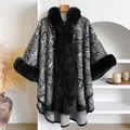 Detail of paisley pattern poncho with black faux fur trim on neckline and edges - Black