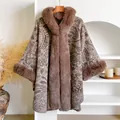 Detail of winter paisley poncho with faux fur trim on a minimalist display stand - Dark Brown