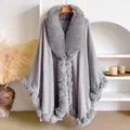Macro shot of plush faux rabbit fur trim and premium grey knitted fabric on a long cape - Silver Gray