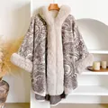 Detail showing paisley patterns and plush faux fur trim on the ivory beige poncho cloak - Beige