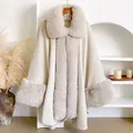Detailed view of the luxury beige faux fur collar and trim on a soft knitted winter cape - 98x130cm / Off White