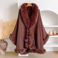 Chocolate brown oversized poncho with faux rabbit fur collar and hem in a minimalist interior - Coffee